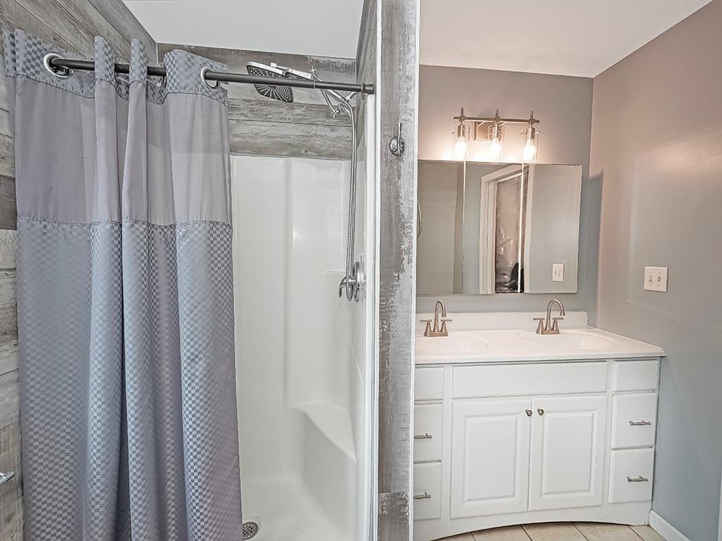 1928 Dime Road Vandergrift, PA 15690 - Photo 22 of 41 a bathroom with a sink mirror and a shower