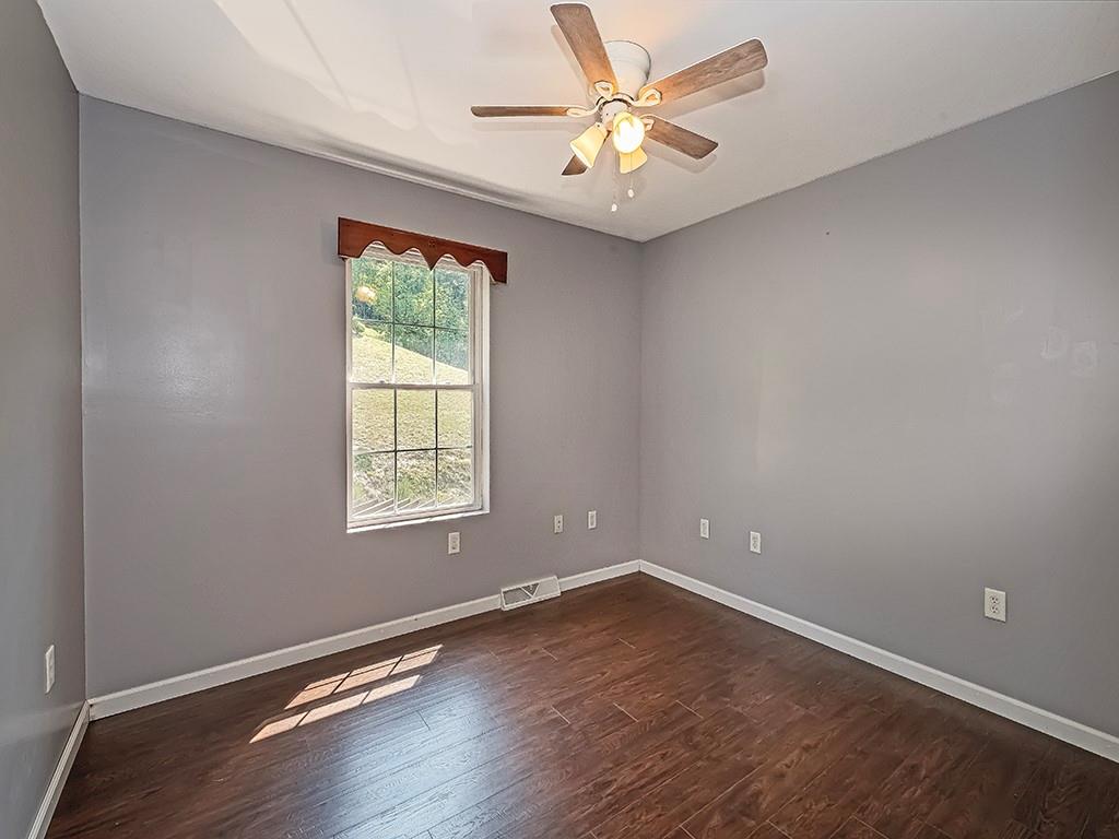 1928 Dime Road Vandergrift, PA 15690 - Photo 23 of 41 an empty room with wooden floor and window