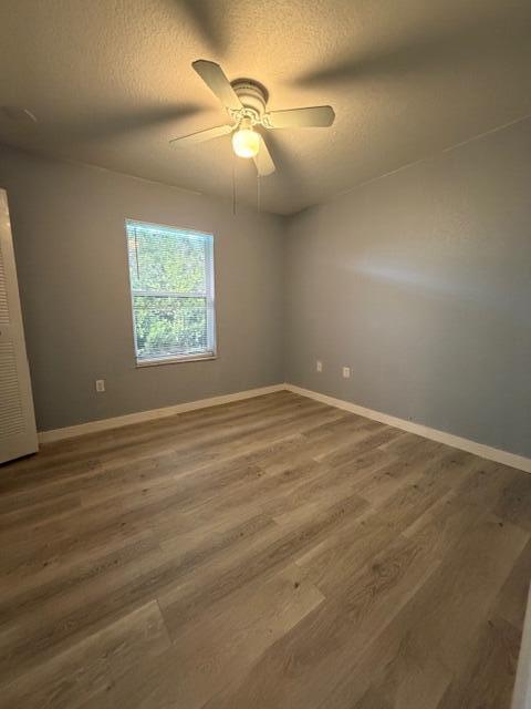 3282 Northwest 75th Way Davie, FL 33024 - Photo 5 of 13 an empty room with wooden floor and windows