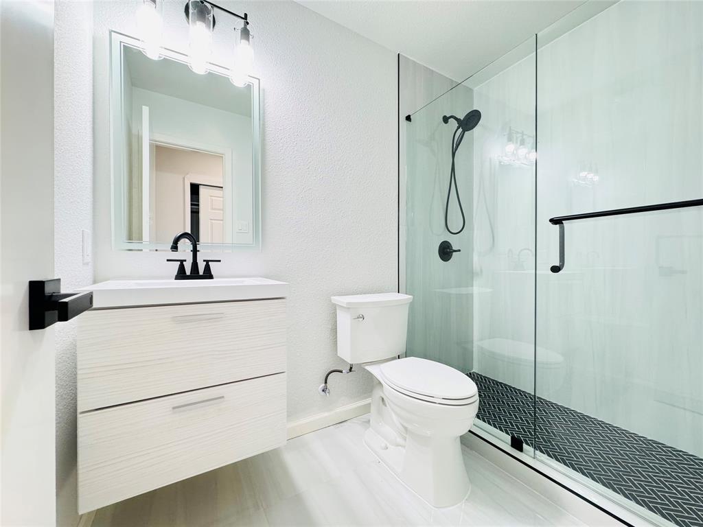 21 Grant Circle Richardson, TX 75081 - Photo 17 of 24 a bathroom with a toilet sink shower and mirror