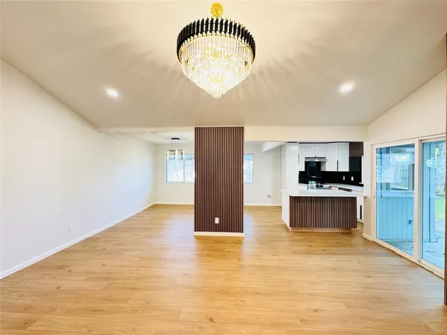 a view of kitchen with stainless steel appliances granite countertop cabinets and wooden floor