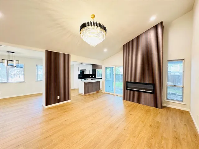 a kitchen with stainless steel appliances kitchen island granite countertop wooden cabinets and granite counter tops