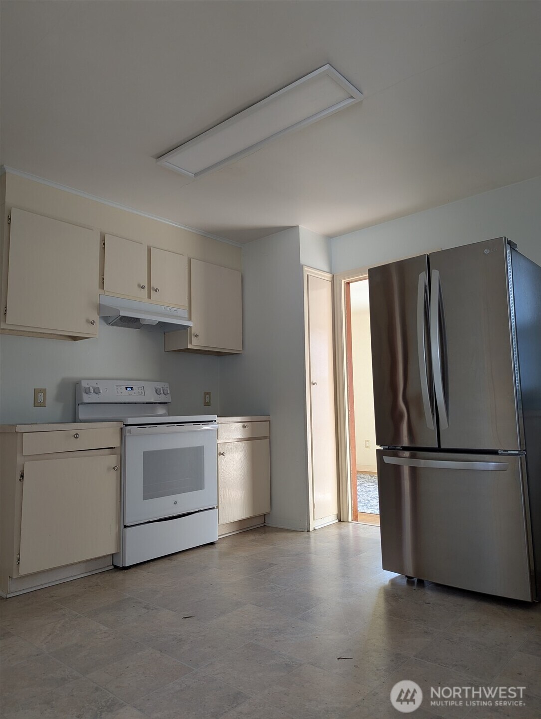 1611 4th Street Marysville, WA 98270 - Photo 5 of 8 a kitchen with stainless steel appliances granite countertop a refrigerator sink and stove