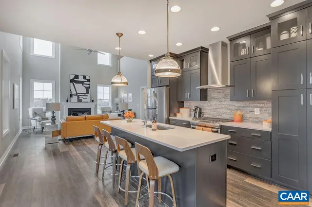 a kitchen with a table chairs sink and wooden floor
