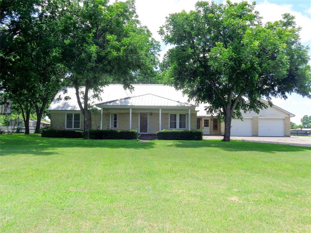 1717 Pipeline Road Cleburne, TX 76033 - Photo 21 of 33 Single-story brick exterior with a metal roof and an expansive front lawn