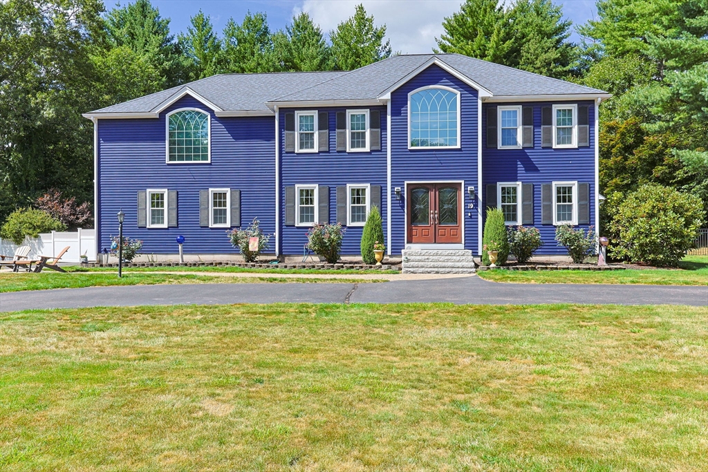 a front view of a house with swimming pool and yard