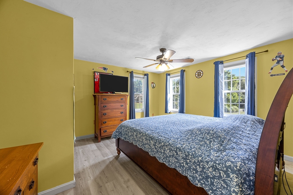 19 King Philip Path Mendon, MA 01756 - Photo 18 of 42 a bedroom with a bed and a flat screen tv