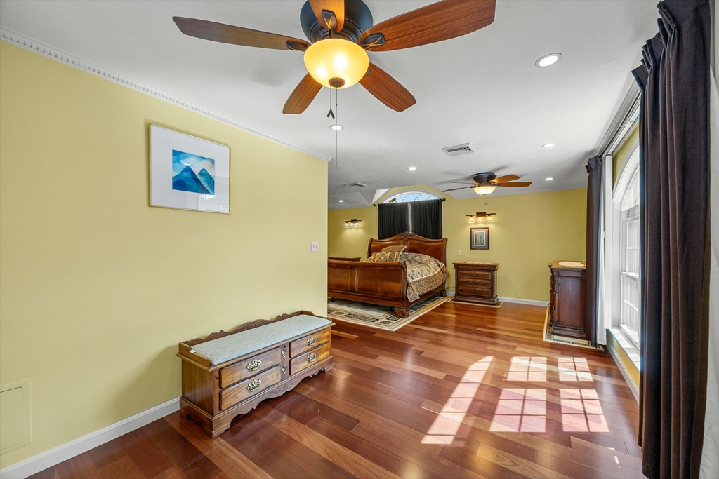 19 King Philip Path Mendon, MA 01756 - Photo 29 of 42 a bedroom with a bed and a chandelier