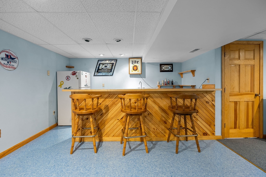 19 King Philip Path Mendon, MA 01756 - Photo 34 of 42 a living room with a table and chairs