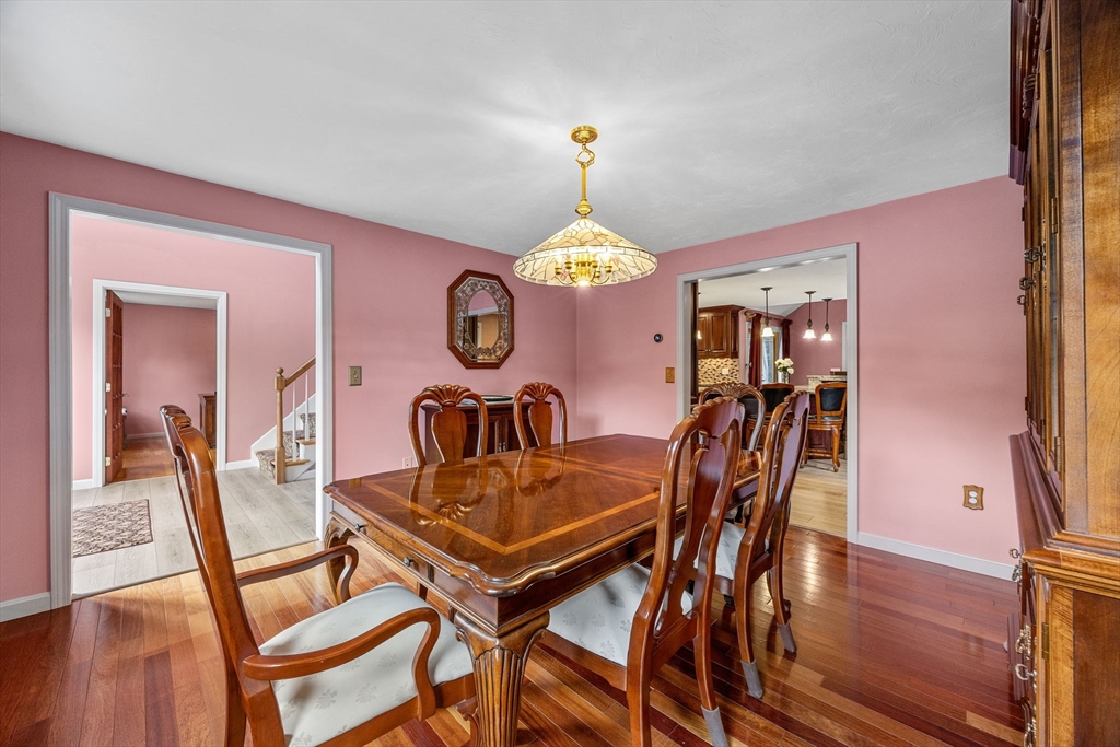19 King Philip Path Mendon, MA 01756 - Photo 5 of 42 a view of a dining room with furniture and a chandelier