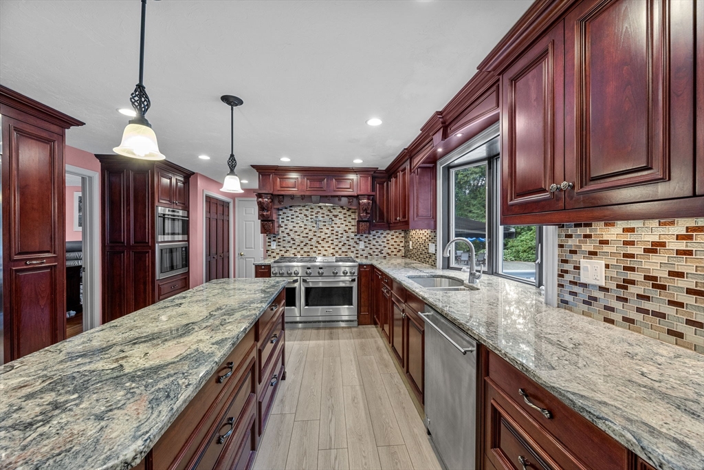 19 King Philip Path Mendon, MA 01756 - Photo 7 of 42 a large kitchen with granite countertop a large counter top appliances and cabinets