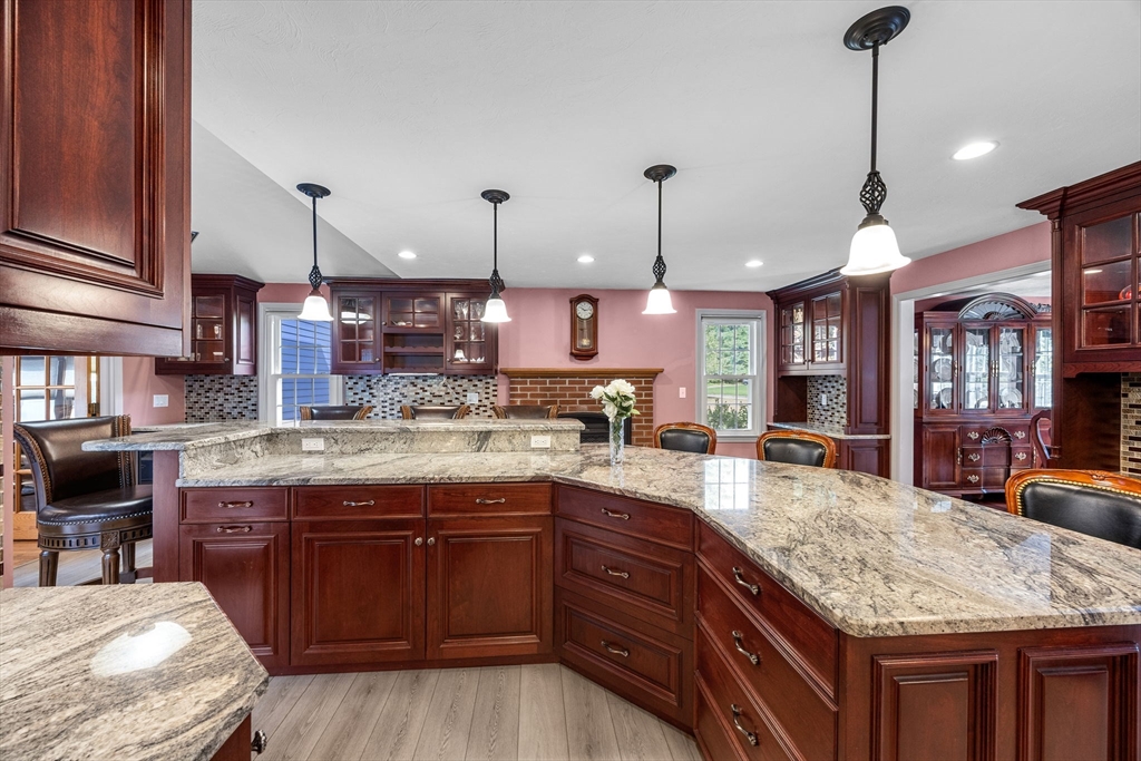 19 King Philip Path Mendon, MA 01756 - Photo 10 of 42 a kitchen with kitchen island granite countertop wooden cabinets and a granite counter tops