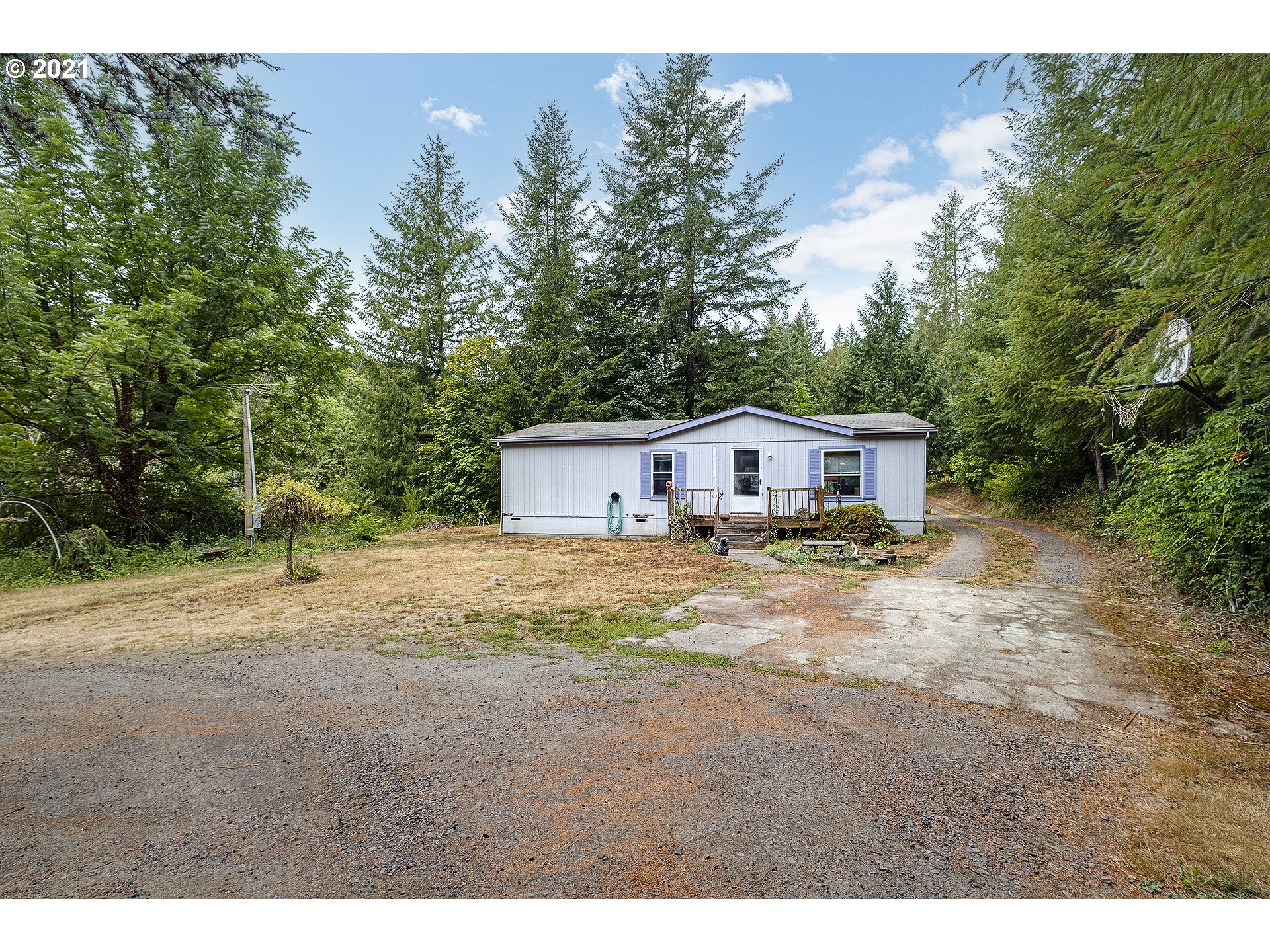 49213 Southwest Patton Valley Road Gaston, OR 97119 - Photo 1 of 32 a aerial view of a house with yard and trees in the background