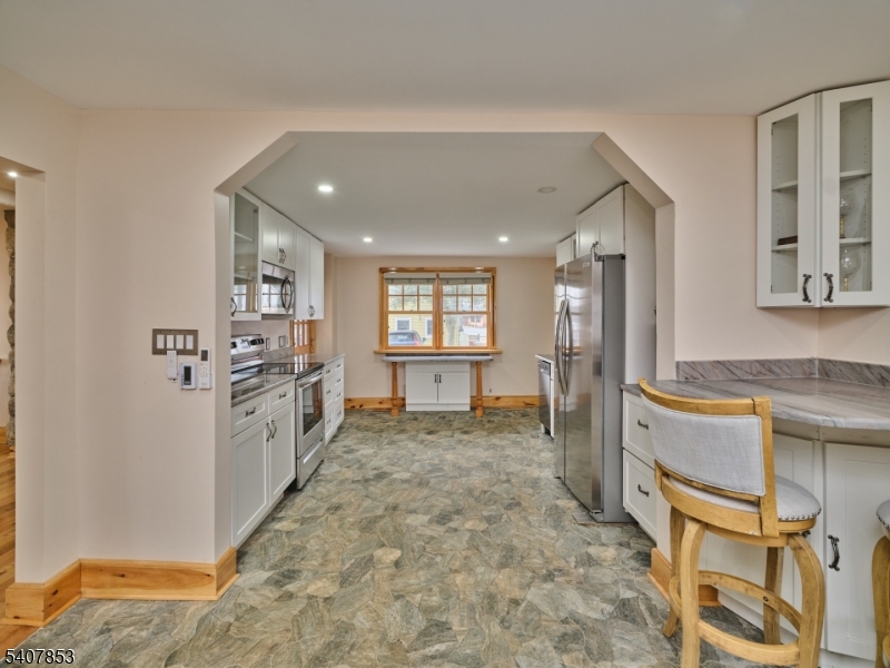 1387 Monmouth Road Eastampton, NJ 08060 - Photo 16 of 35 a large white kitchen with granite countertop a refrigerator and cabinets
