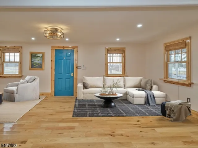 a view of a livingroom with wooden floor and a flat screen tv