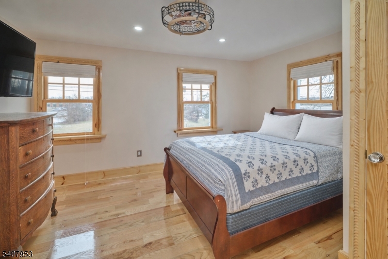 1387 Monmouth Road Eastampton, NJ 08060 - Photo 29 of 35 a bedroom with a bed and a chandelier