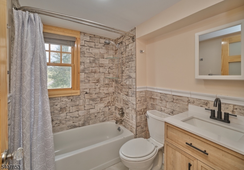 1387 Monmouth Road Eastampton, NJ 08060 - Photo 30 of 35 a bathroom with a bathtub shower sink vanity mirror and toilet