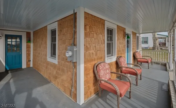 a balcony with furniture and wooden floor
