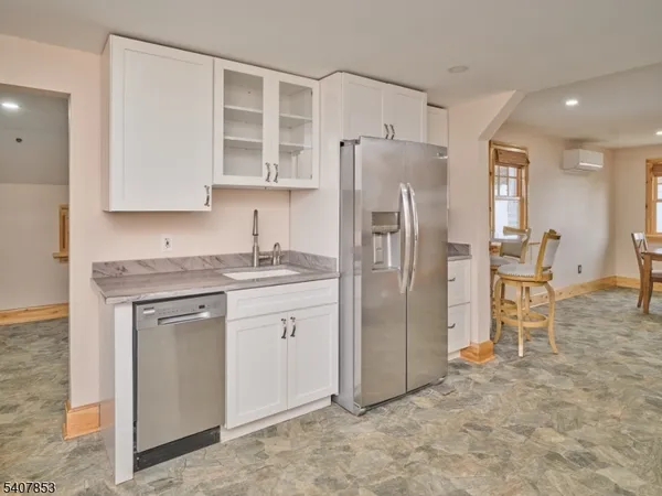 a kitchen with stainless steel appliances granite countertop a refrigerator and a stove top oven