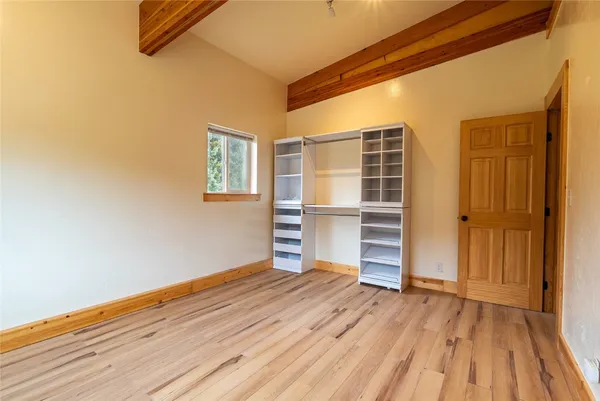 a view of room with wooden floor and closet