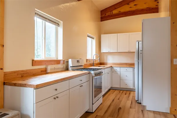 a kitchen with a sink window and cabinets