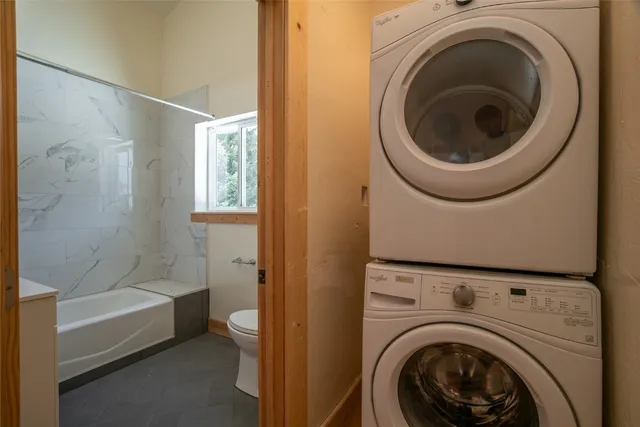 a bathroom with a washer and a bathtub