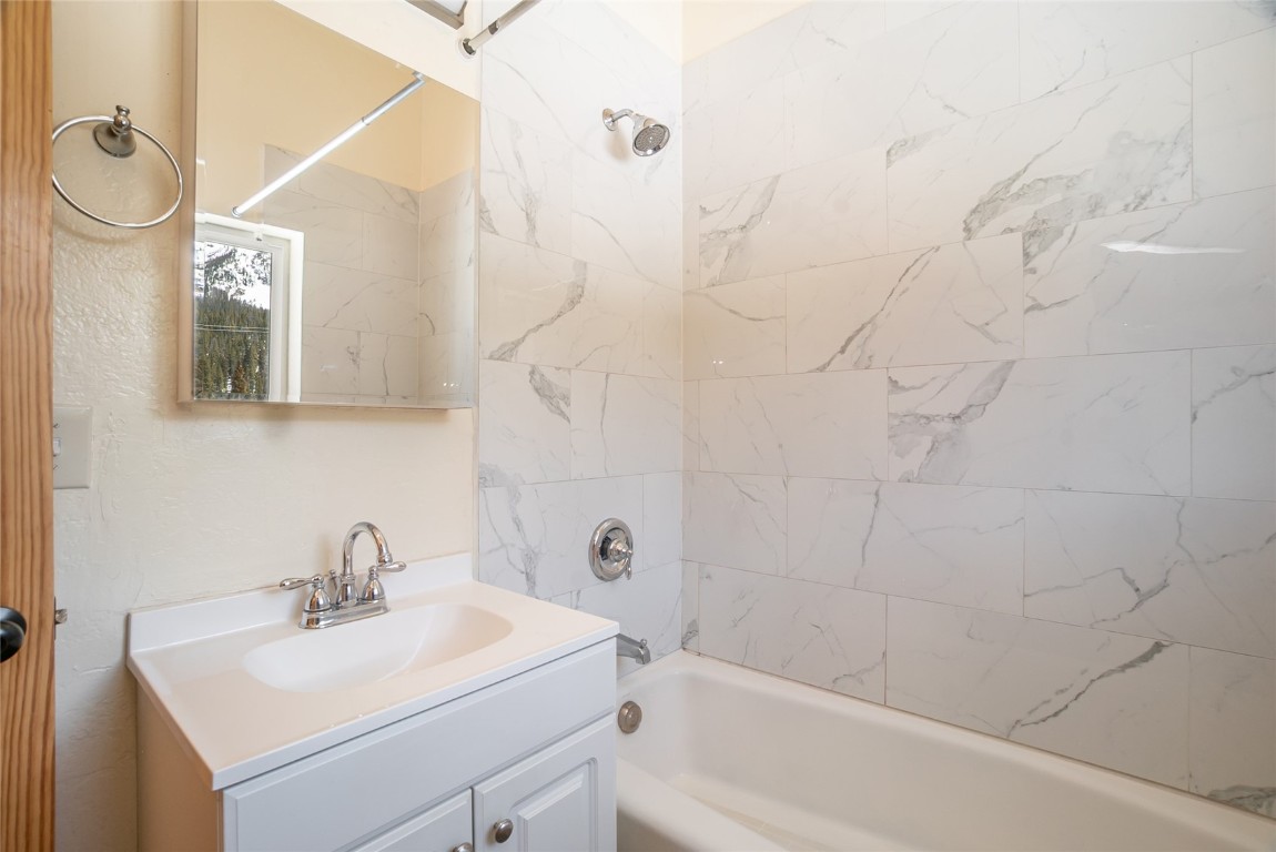 5277 Montezuma Road Montezuma, CO 80435 - Photo 17 of 30 a bathroom with a sink mirror toilet and bathtub