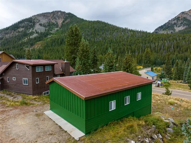 a view of a house with a yard and mountain