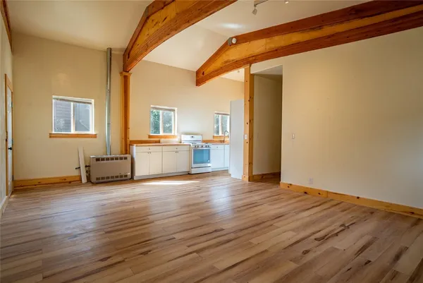 a view of a livingroom with wooden floor and a ceiling fan