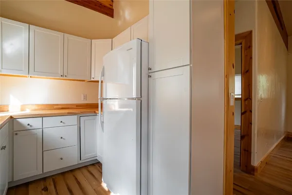 a white refrigerator freezer sitting inside of a kitchen