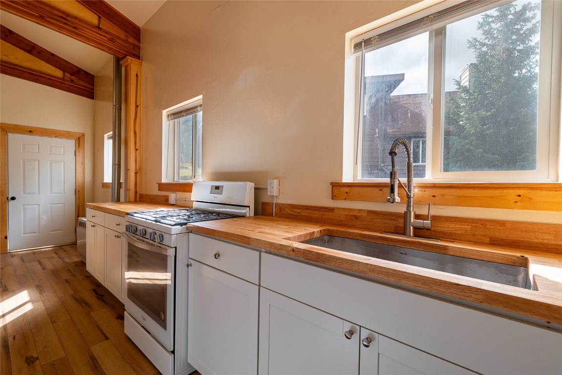 5277 Montezuma Road Montezuma, CO 80435 - Photo 9 of 30 a kitchen with stainless steel appliances granite countertop a sink and a stove