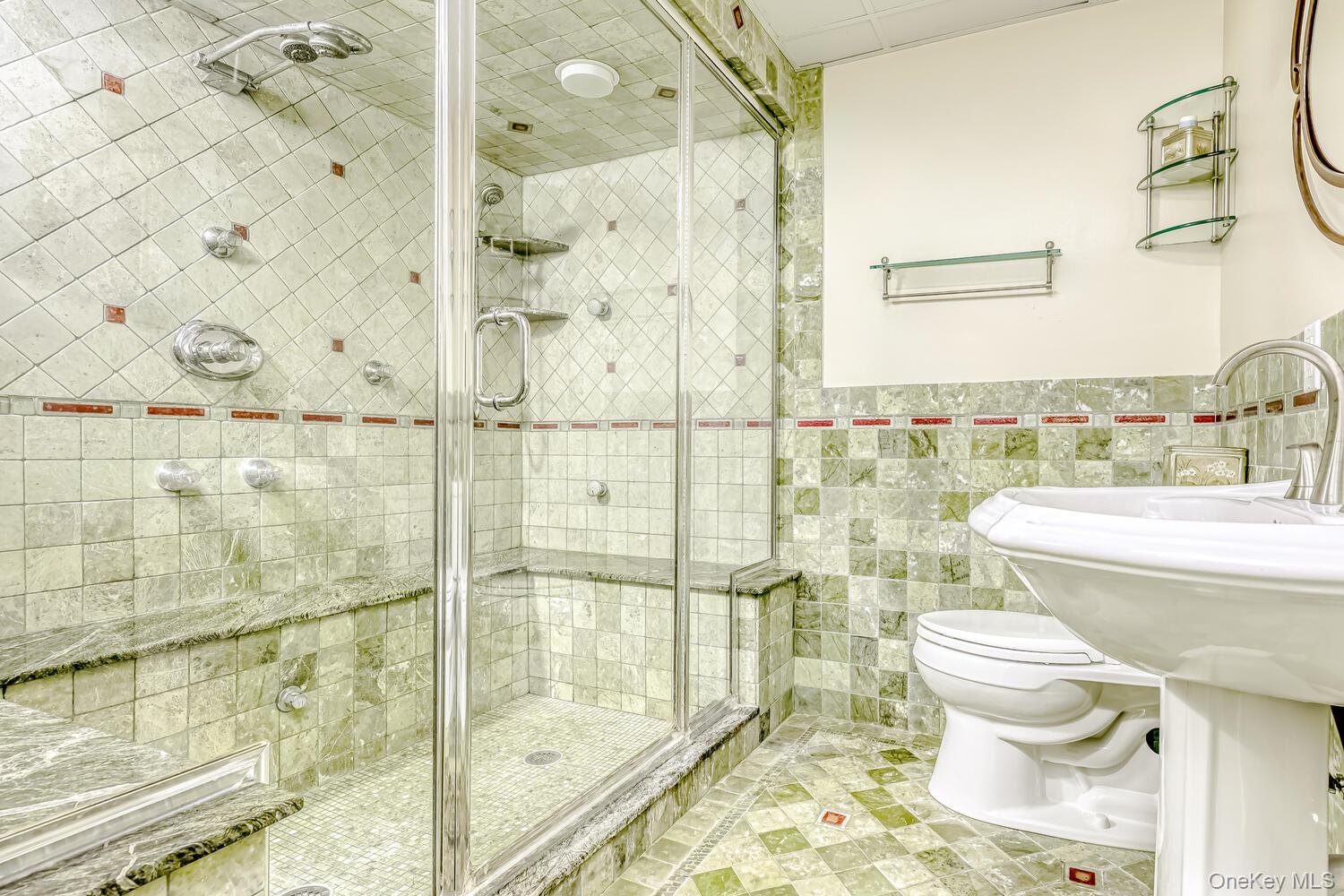 22 Golden Road Suffern, NY 10901 - Photo 36 of 41 Bathroom featuring tile walls, light tile patterned flooring, a shower stall, and a wainscoted wall