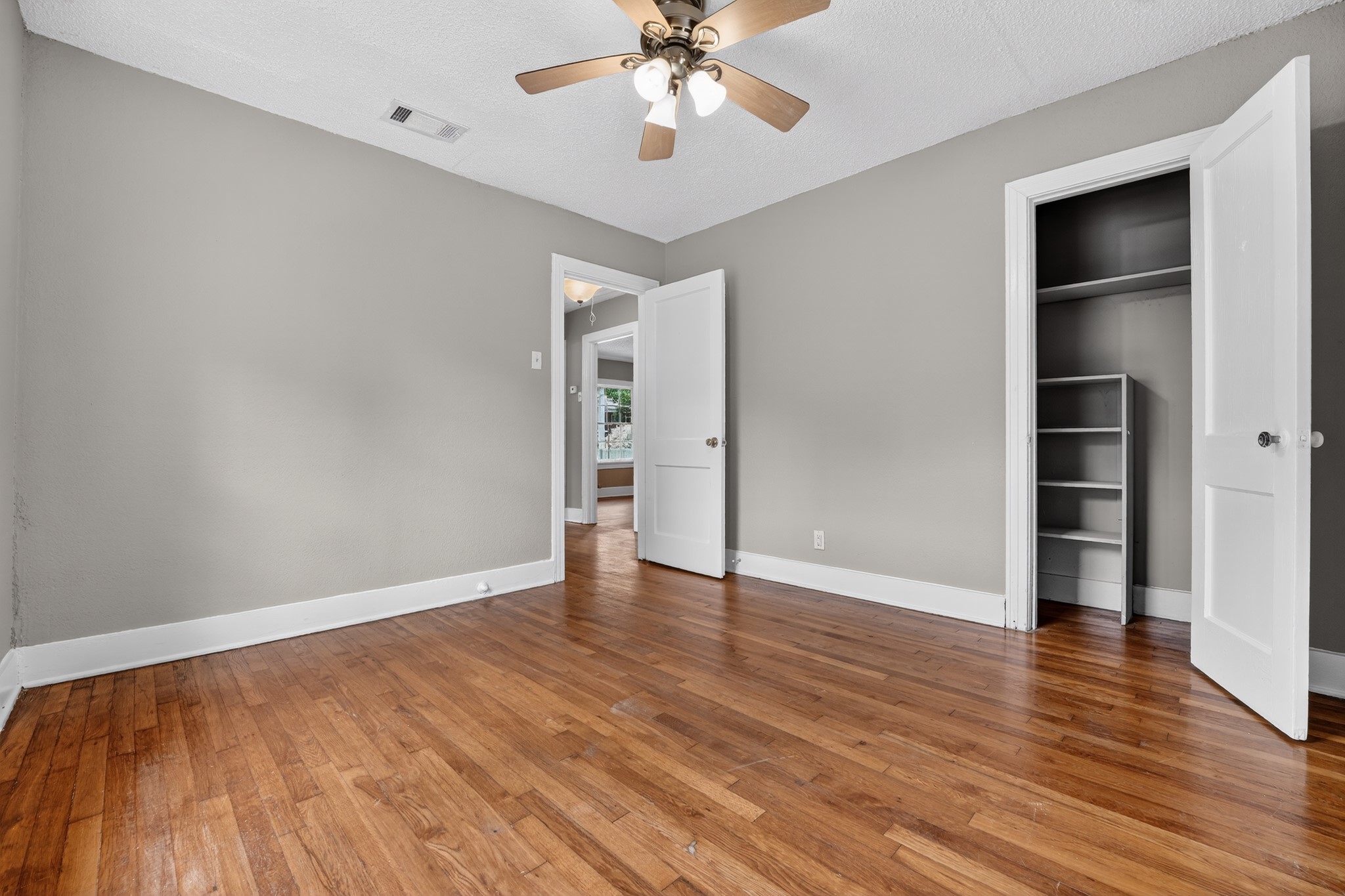 4907 Duval Street Austin, TX 78751 - Photo 24 of 31 wooden floor in an empty room with a window