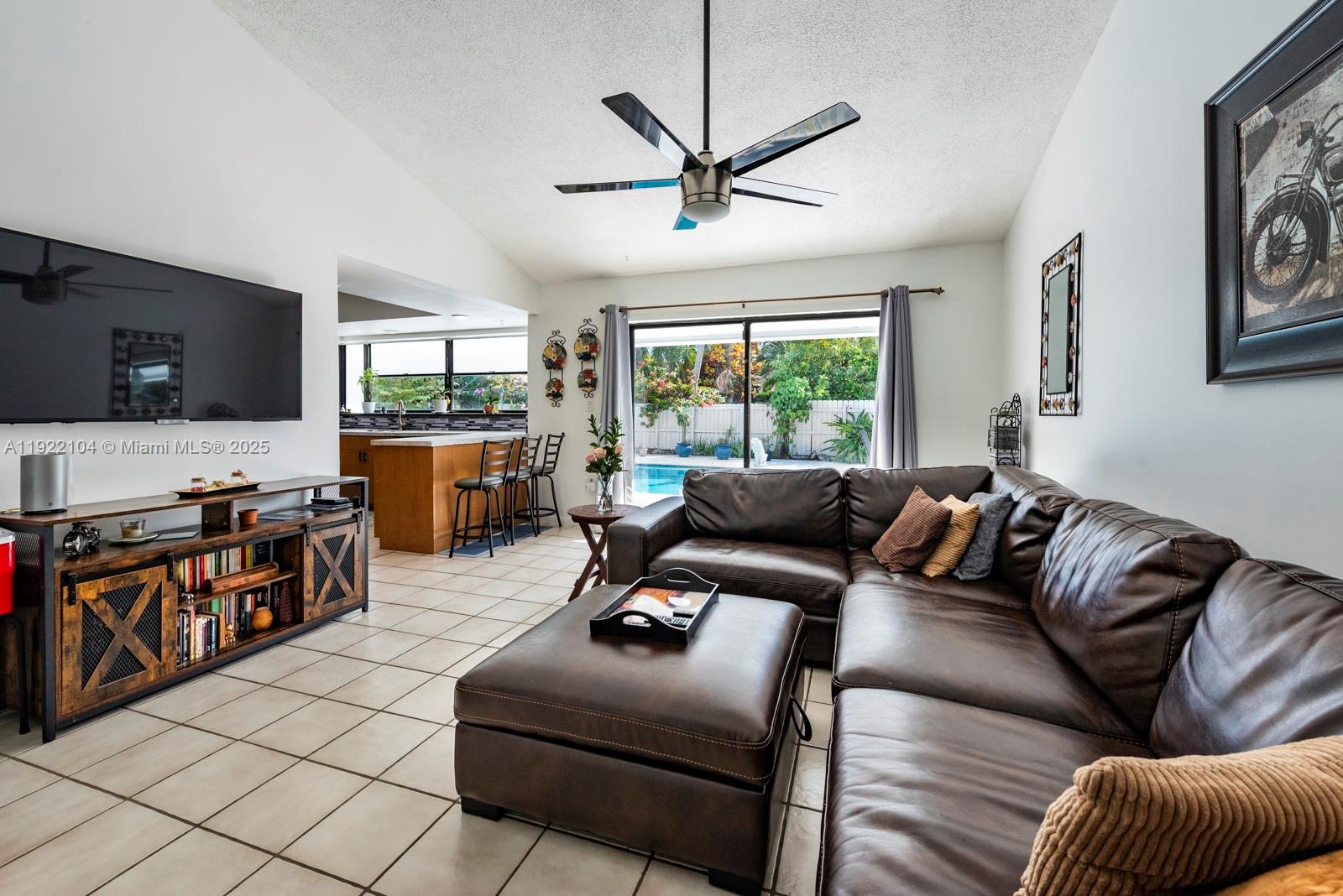 11724 Southwest 95th Street Miami, FL 33186 - Photo 11 of 25 a living room with furniture ceiling fan and a window