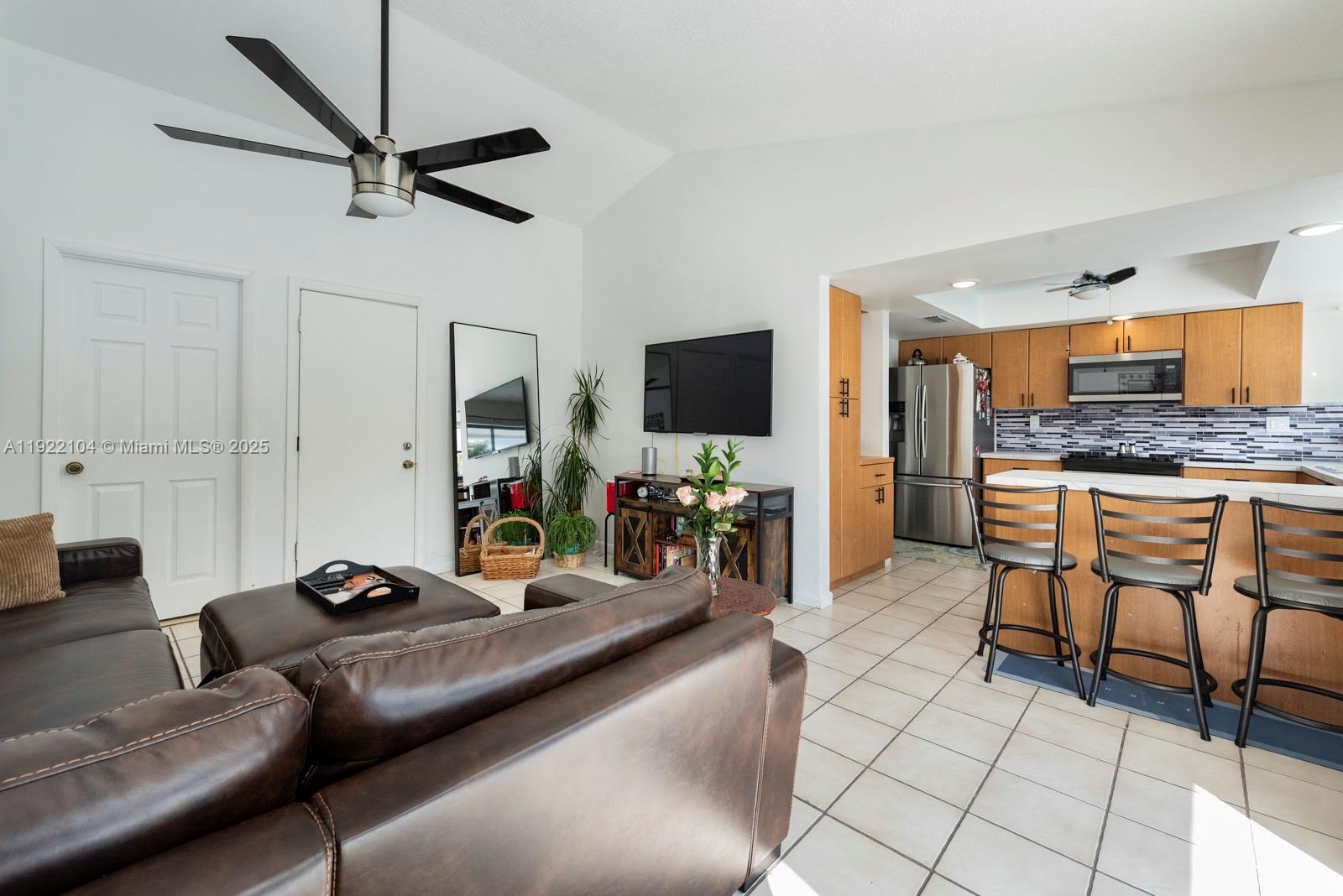 11724 Southwest 95th Street Miami, FL 33186 - Photo 12 of 25 a living room with furniture and a flat screen tv