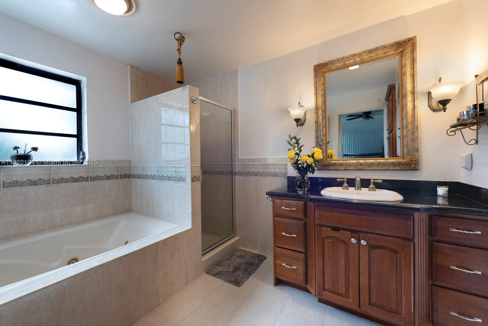 11724 Southwest 95th Street Miami, FL 33186 - Photo 16 of 25 a bathroom with a tub sink and mirror