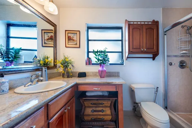 a bathroom with a sink a toilet and mirror