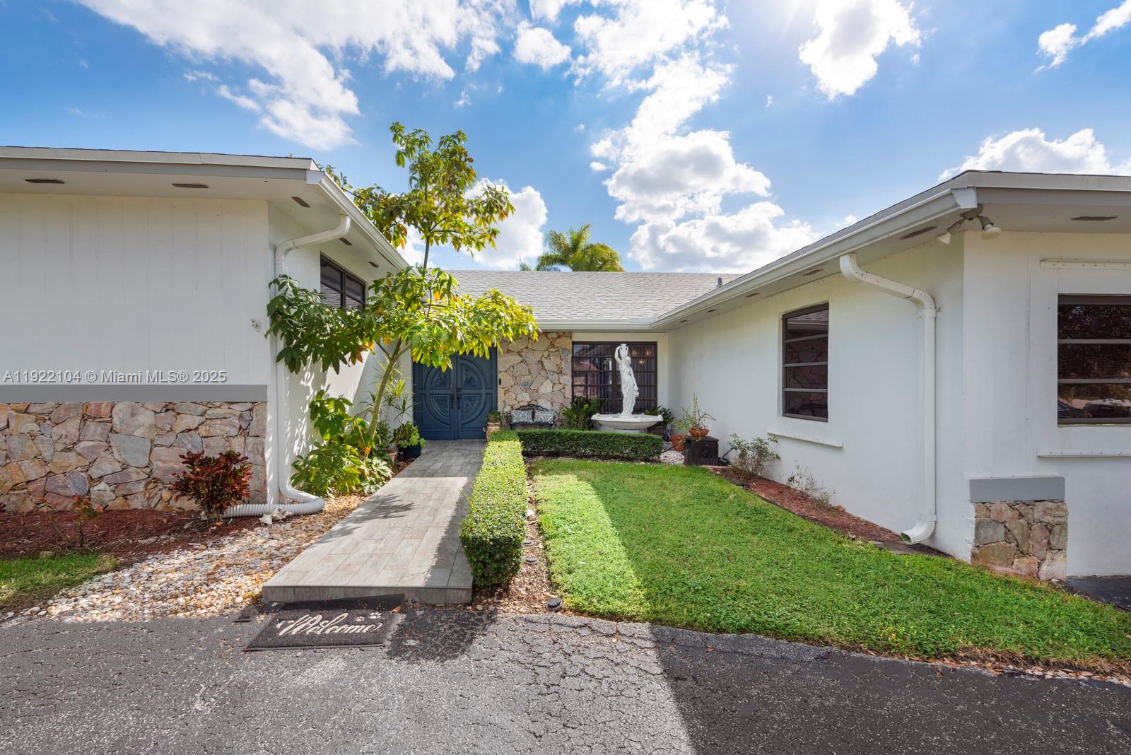 11724 Southwest 95th Street Miami, FL 33186 - Photo 2 of 25 a front view of a house with garden