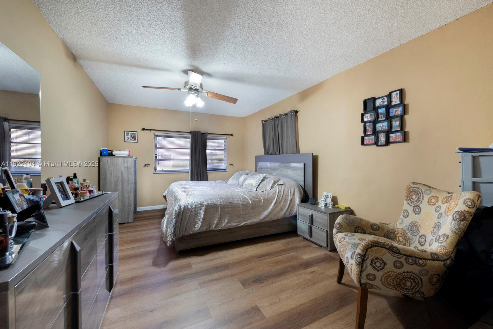 11724 Southwest 95th Street Miami, FL 33186 - Photo 21 of 25 a bedroom with a bed and wooden floor