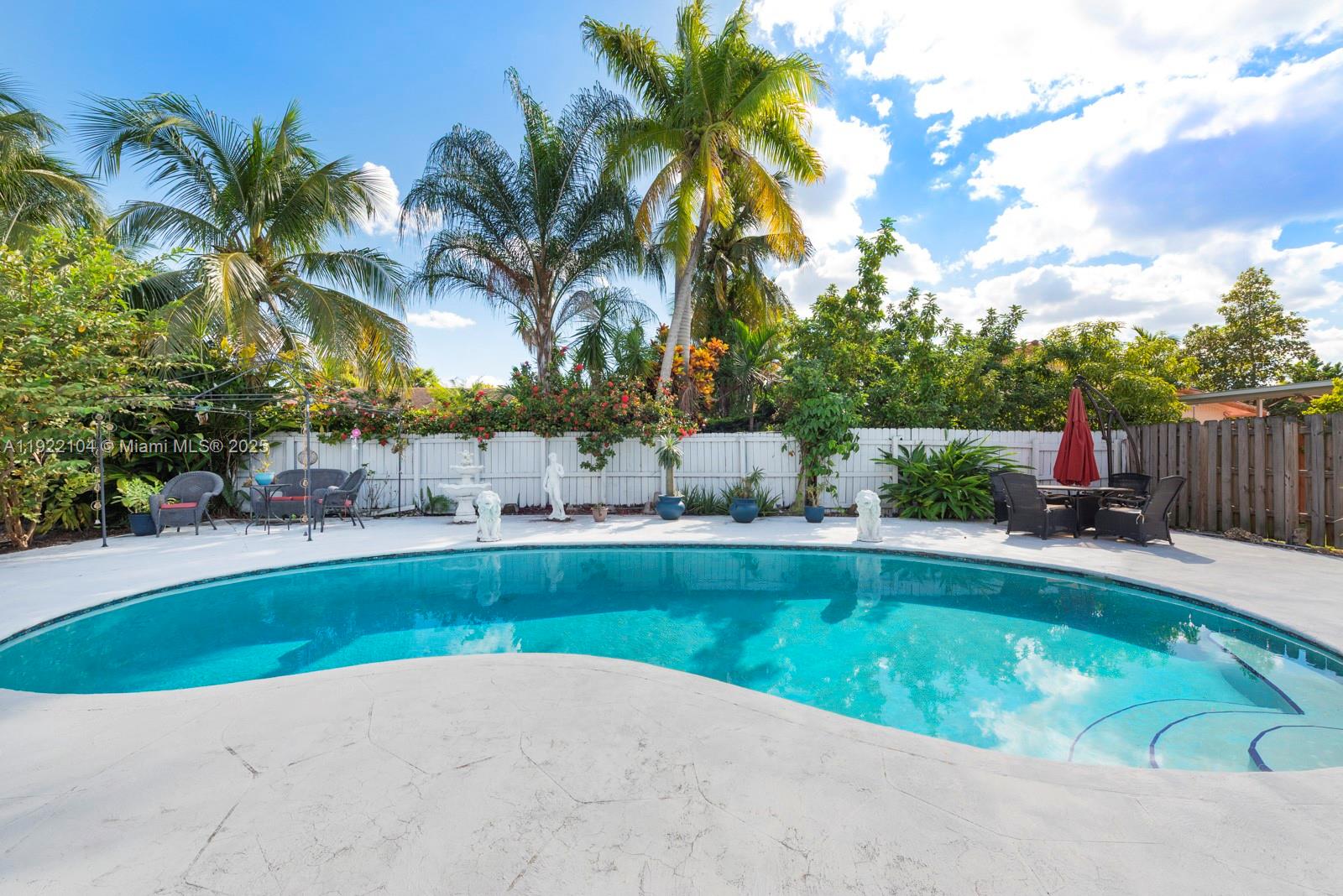 11724 Southwest 95th Street Miami, FL 33186 - Photo 23 of 25 a view of backyard with swimming pool and seating space