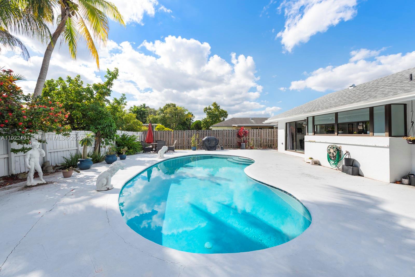 11724 Southwest 95th Street Miami, FL 33186 - Photo 25 of 25 a view of a house with a swimming pool and a yard