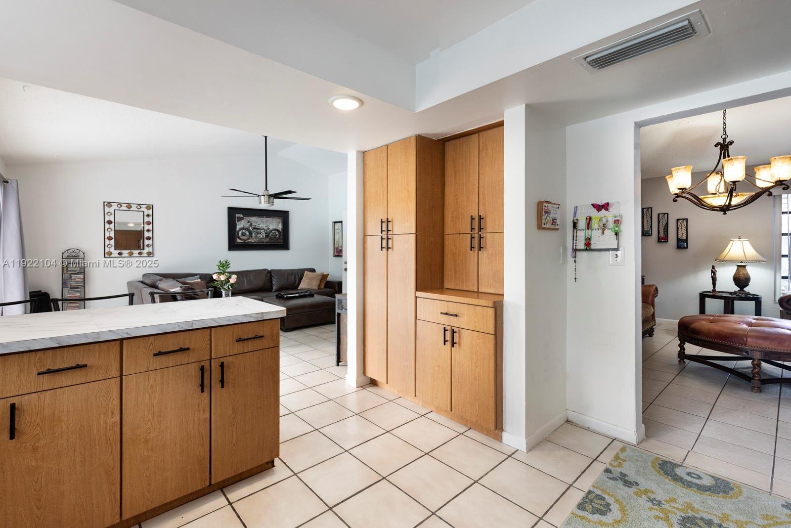 11724 Southwest 95th Street Miami, FL 33186 - Photo 10 of 25 a kitchen with cabinets and refrigerator