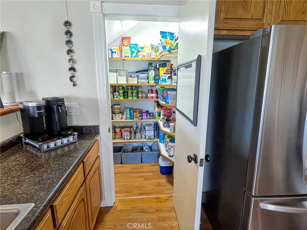 a kitchen with stainless steel appliances granite countertop a refrigerator and a stove