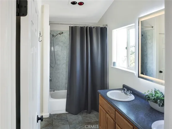 a bathroom with a sink a mirror and a shower