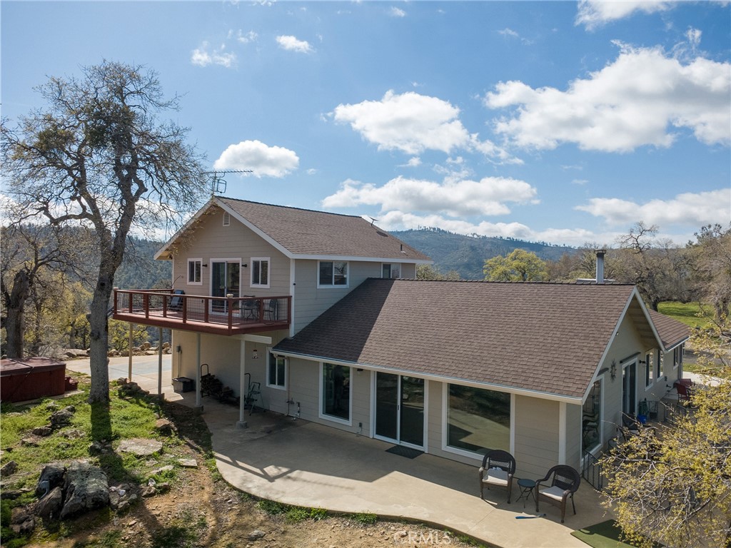 6097 Sherlock Road Midpines, CA 95345 - Photo 27 of 37 a front view of a house with yard porch and mountain view in back