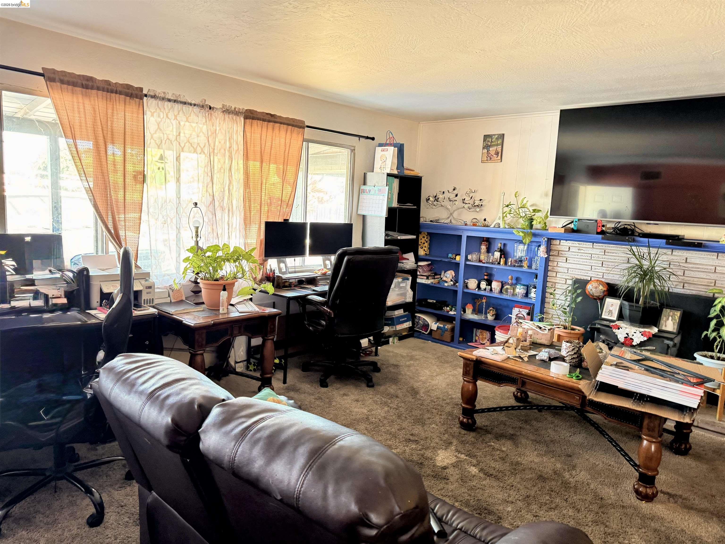 7031 Power Inn Road Sacramento, CA 95828 - Photo 5 of 8 a living room with furniture and a flat screen tv