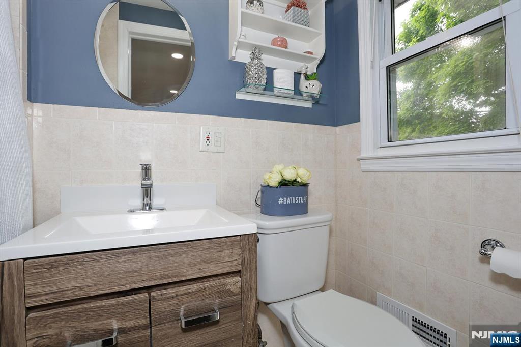 30 Brookfield Road Dumont, NJ 07628 - Photo 16 of 50 a bathroom with a sink mirror and toilet
