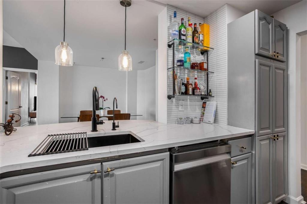 3475 Oak Valley Road Northeast, Unit 1630 Atlanta, GA 30326 - Photo 18 of 38 a kitchen with kitchen island a counter space a sink and appliances