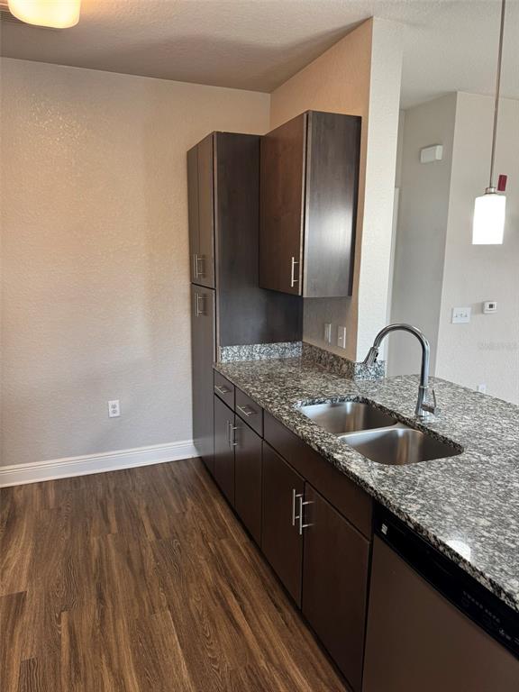 2420 Ann Rou Road, Unit 201 Tavares, FL 32778 - Photo 11 of 25 a kitchen with granite countertop stainless steel appliances and wooden cabinets