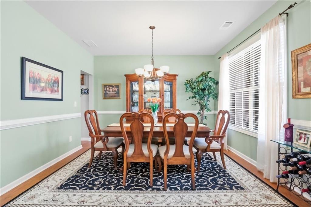 525 Widgeon Way Jefferson, GA 30549 - Photo 11 of 65 a view of a dining room with furniture window and wooden floor